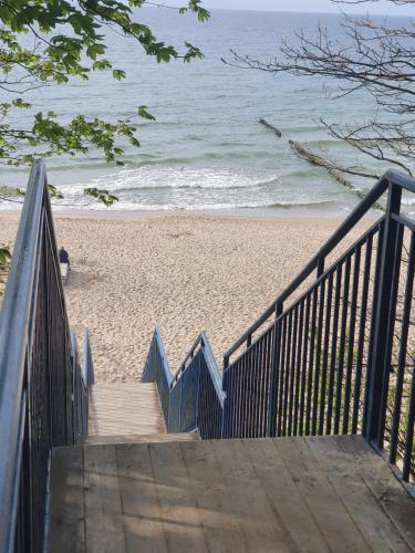 a set of stairs leading to the beach at Aparthotel REWAL in Rewal