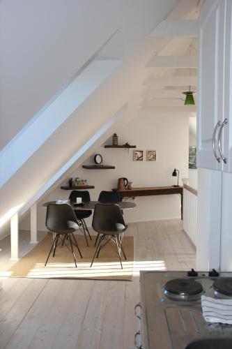 a room with chairs and a table under a staircase at Munkebjerg Bed & Breakfast in Børkop