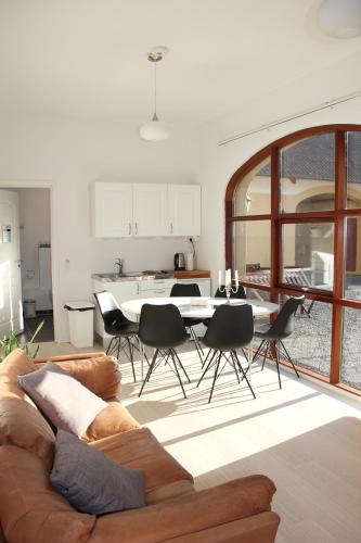 a living room with a couch and a table and chairs at Munkebjerg Bed & Breakfast in Børkop