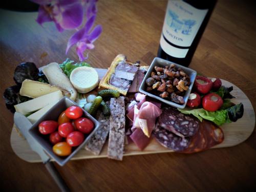 a plate of food with different types of food on a table at Arche de Lanoë jacuzzi in Labastide-Saint-Pierre