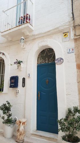 a blue door on the side of a building at Anna's Rose Holiday Home in Monopoli