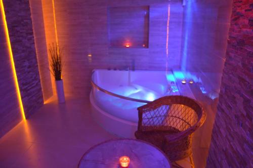 a bathroom with a tub and a table and a chair at Chata Panorama Beskidów in Ustroń