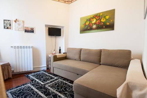 a living room with a couch and a painting on the wall at Anna's Rose Holiday Home in Monopoli
