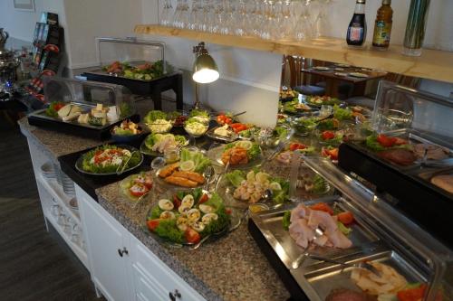 a buffet line with many different types of food at Hotel Villa Undine in Grömitz
