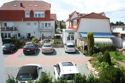 a group of cars parked in a parking lot at Hotel Villa Undine in Grömitz