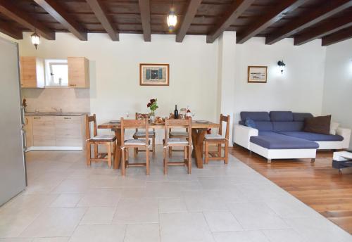 a living room with a table and a blue couch at Vacation Home Mate Ceko in Sukošan