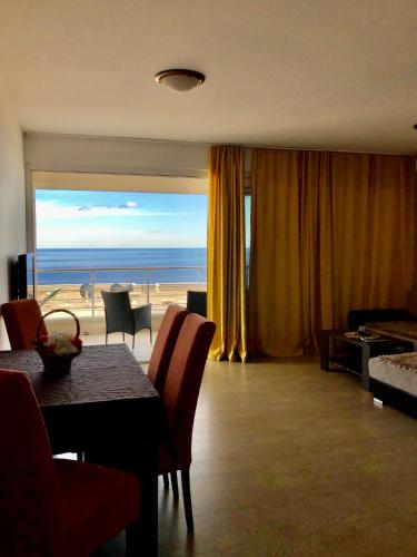 a living room with a table and a view of the ocean at Apartments Violeta in Budva