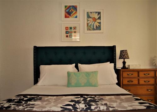 a bedroom with a bed with a green headboard at Urbana in Grand Forks