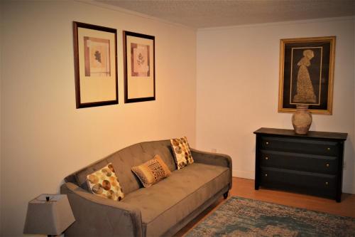 a living room with a couch and a dresser at Urbana in Grand Forks