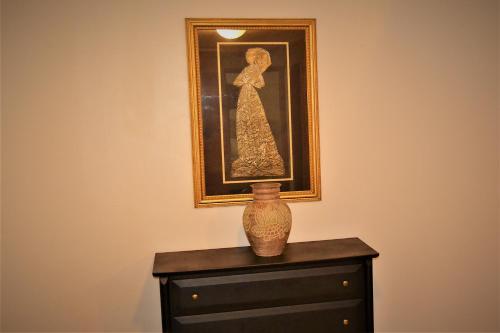 a vase sitting on top of a dresser with a picture at Urbana in Grand Forks