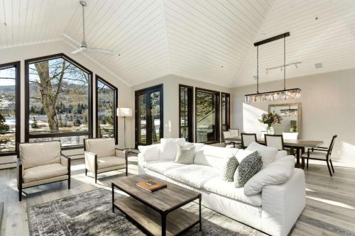 a living room with a white couch and a table at Homestead Townhome in Snowmass Village