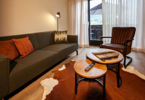 a living room with a couch and a table at Haus 4 Montafon by Pferd auf Wolke in Gaschurn