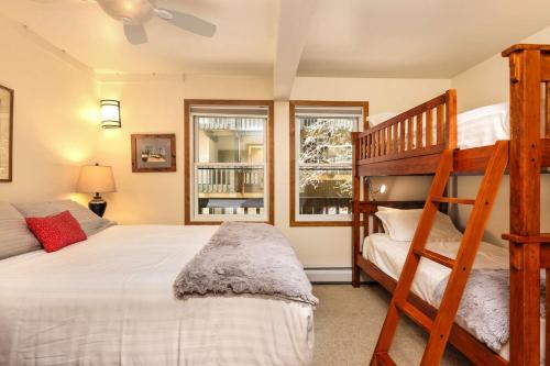 a bedroom with a bunk bed and a ladder at Interlude 103 in Snowmass Village