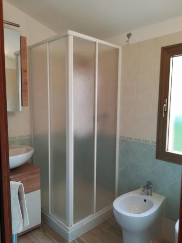 a bathroom with a shower and a toilet and a sink at CASA GAIA in Portoferraio