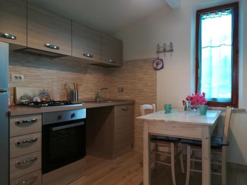 a kitchen with a table and a counter top at CASA GAIA in Portoferraio