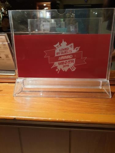 a glass box with a sign on top of a table at Chaiyapoon Inn in Pattaya Central