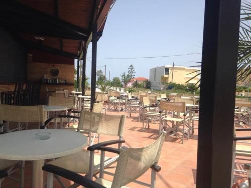 a group of tables and chairs on a patio at Beach House I&II in Alykes