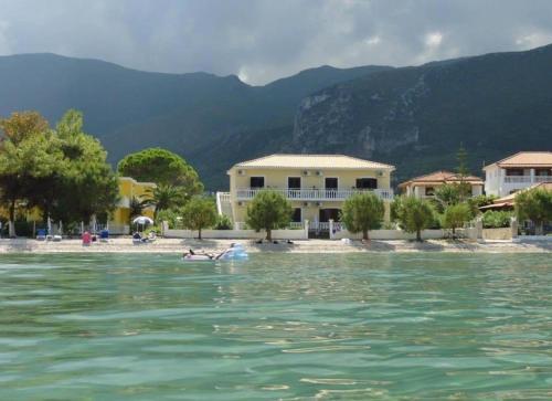 a house on a beach next to the water at Beach House I&II in Alykes