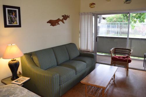 a living room with a couch and a table at Kihei Bay Surf 117 in Kihei