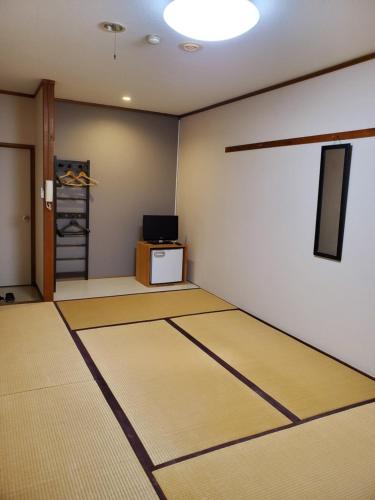 a room with a mat on the floor at Ryokan Kume Himawari Sou in Sakaide