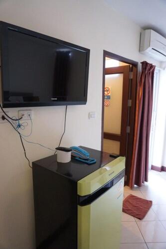 a living room with a flat screen tv on the wall at The One Residence in Udon Thani