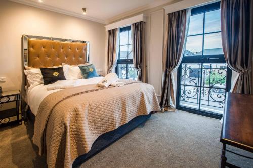 a bedroom with a large bed and a balcony at The Salisbury in Christchurch