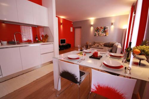 a kitchen and living room with a table and chairs at Apartment Villa Mandria in Opatija