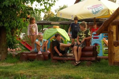 a group of children sitting on a play park at Alba Regia Pansion Egri in Jahodná