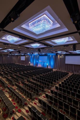 an empty lecture hall with chairs and lights at Mercure Melbourne Albert Park in Melbourne