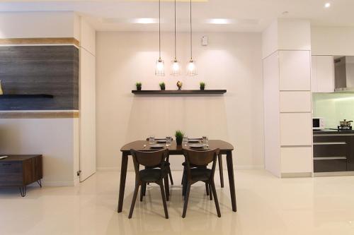 a kitchen and dining room with a table and chairs at Azure Residences by Sleepy Bear Paradigm Mall in Petaling Jaya