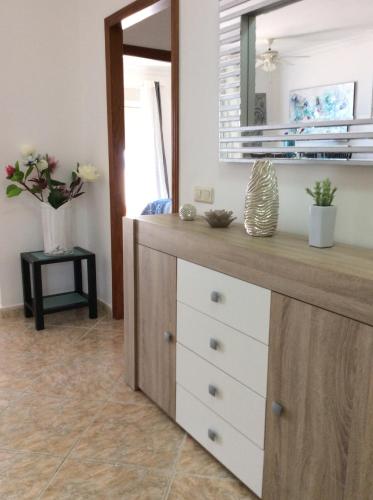 a dresser in a room with a mirror at DUQUESA BY THES SEA - HACIENDA GUADALOUPE in Manilva