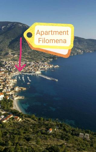 a sign that reads apartment flerno flying over a body of water at Apartment Filomena in the center in Komiža