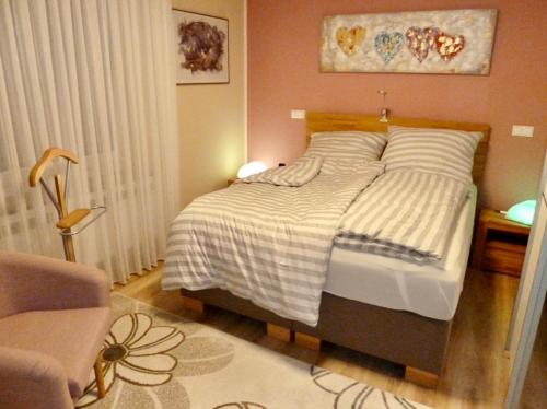 a bedroom with a bed and a table with a chair at Exklusives Wohnen am Stadtpark in Bad Driburg