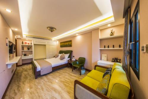 a hotel room with a bed and a couch at Lansheng yard in Xiamen