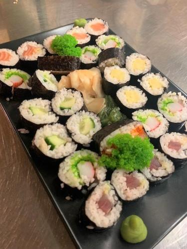 a plate of sushi on top of a table at Hotel Bünda Davos in Davos