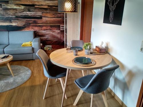 a dining room with a table and chairs at Ferienwohnung Fichtelzauber in Mehlmeisel