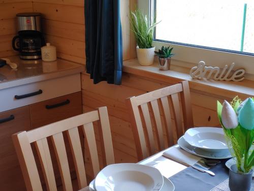 a kitchen with a table and chairs and a table and a table and chairsktop at Apartamenty przy Jeziorze Żywieckim z widokiem na Skrzyczne in Żywiec