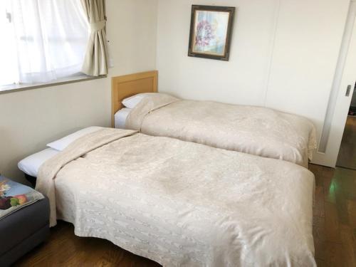 A bed or beds in a room at Fuji Gotemba Condominium Tannpopo