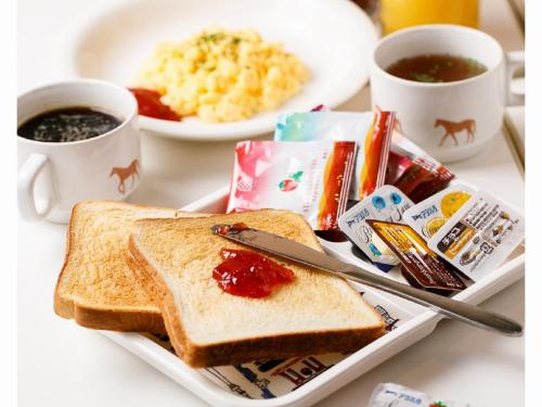 a plate with toast and jam and a cup of coffee at Sakura Hotel Jimbocho in Tokyo