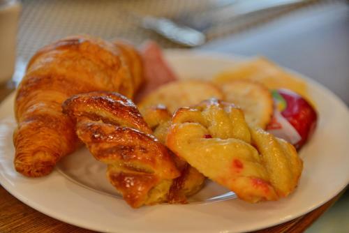 a plate of food with bread and pastries on it at City Lodge Hotel Fourways in Johannesburg