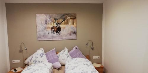 a bedroom with two beds and a picture of a deer at Ferienwohnung Hartmann in Winterberg