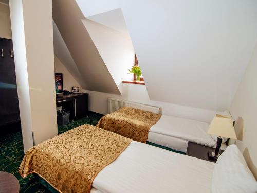 Postel nebo postele na pokoji v ubytování Hotel Zamek Gniew