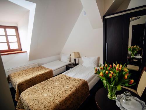 Postel nebo postele na pokoji v ubytování Hotel Zamek Gniew