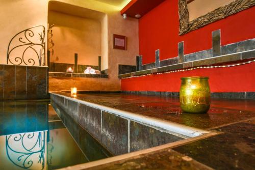 a bathroom with a counter with a vase on it at Hôtel Spa Mendi Alde in Ossès