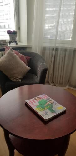 a book sitting on top of a coffee table in a living room at Lentävä Kalakukko -Veturi B&B in Kuopio