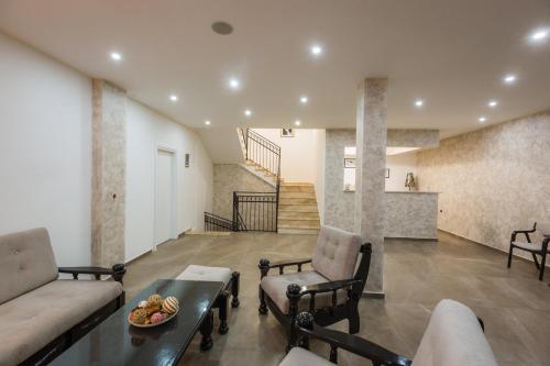 a living room with a couch and a table at Hotel Dapčević in Cetinje