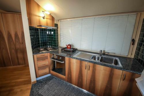 a small kitchen with a sink and a window at Appartamenti Pirovano Bormio in Bormio