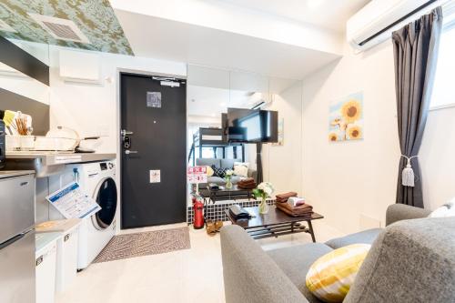 a kitchen and living room with a washer and dryer at Space F Yoyogi in Tokyo