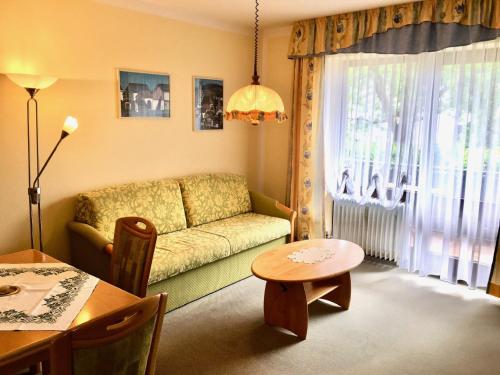 a living room with a couch and a table at Ferienwohnungen Biermeier in Bad Birnbach