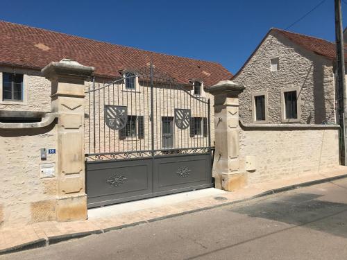 a black garage door with a gate on a building at Le Charles V in Meursault